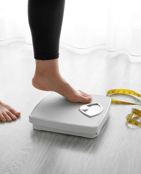 woman getting on the scale